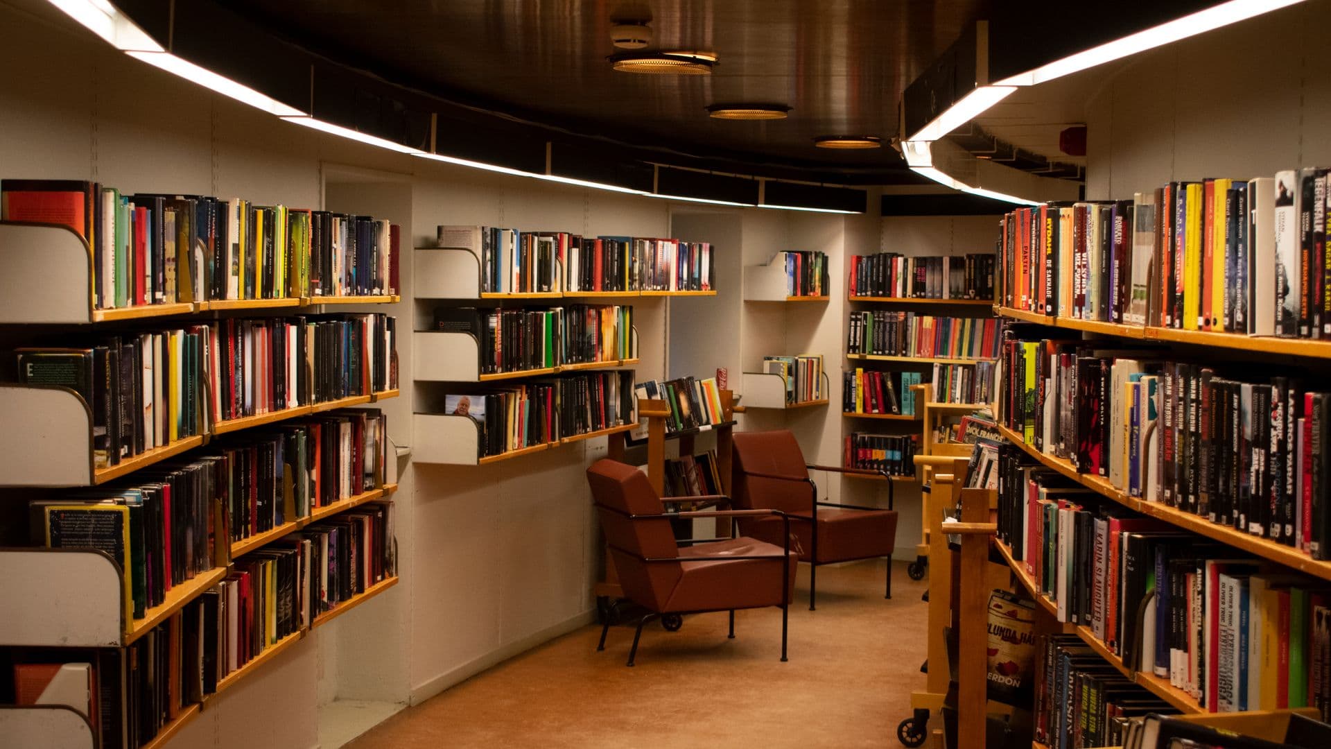 Grand historic library reading room lined with books